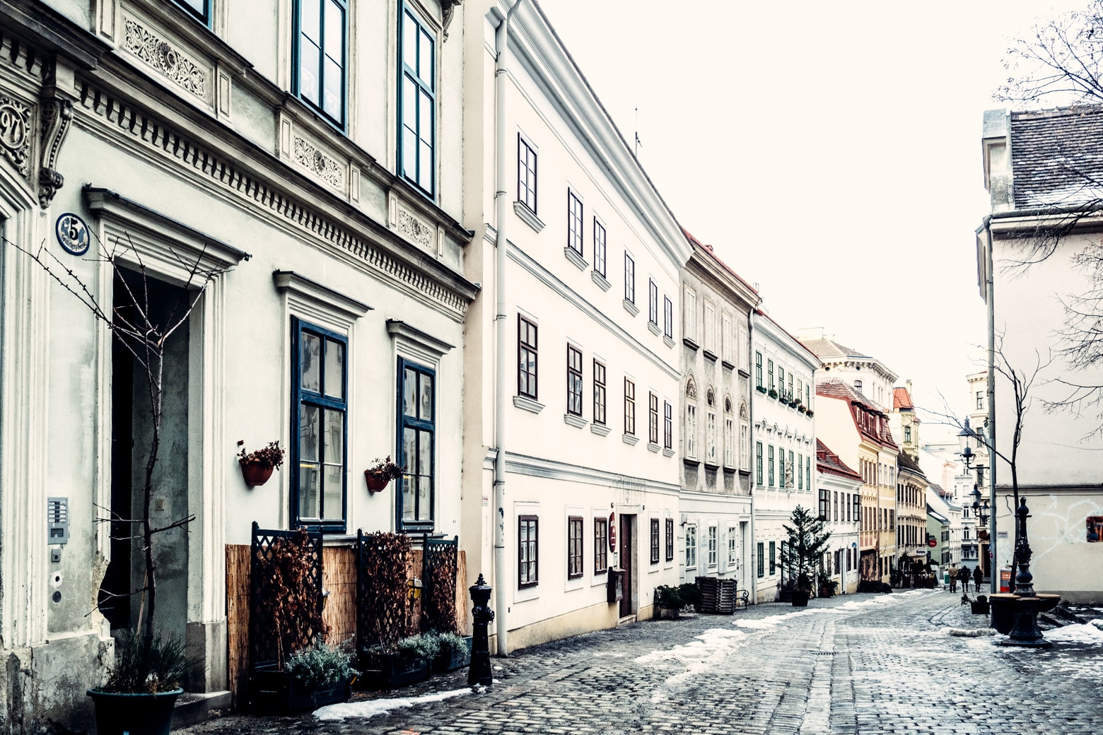Cobblestone street in Vienna with snow.